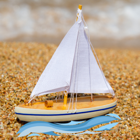 Model sailboat cruising on water