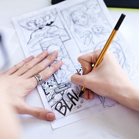 Hands Drawing a Comic