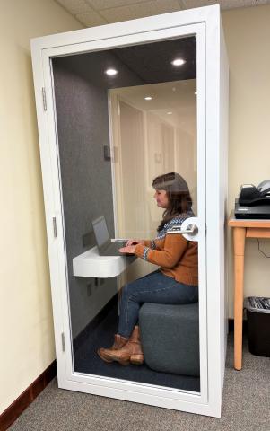 Woman using a laptop in the Quiet Booth 