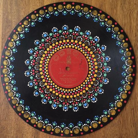 Vinyl record with dot mandala painted on it