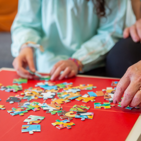 people working on a jigsaw puzzle together