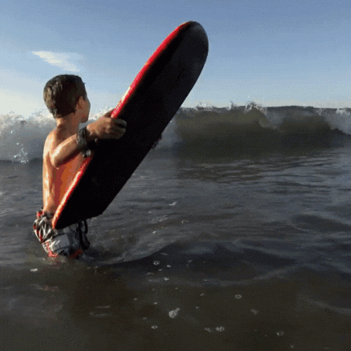 Child boogie boarding in the ocean