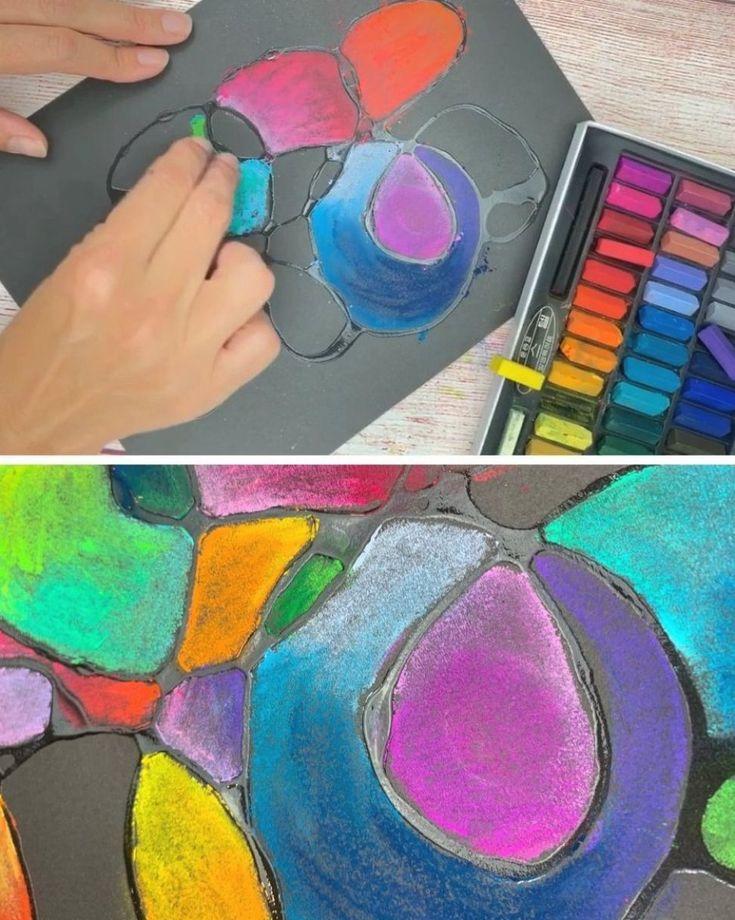 A human handing using chalk pastels to create a vibrant abstract doodle