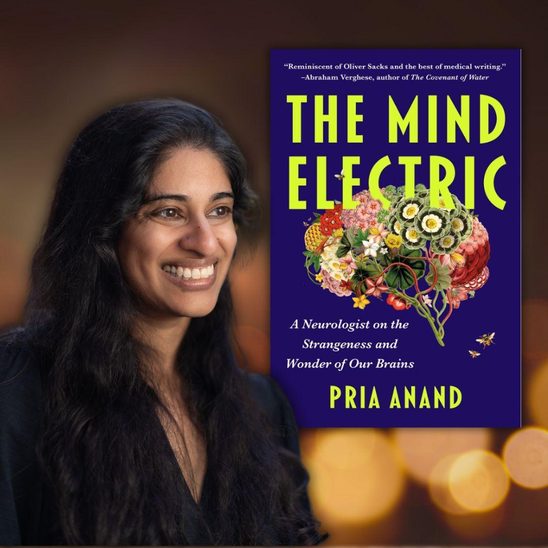 Woman posing with the cover of the book The Mind Electric